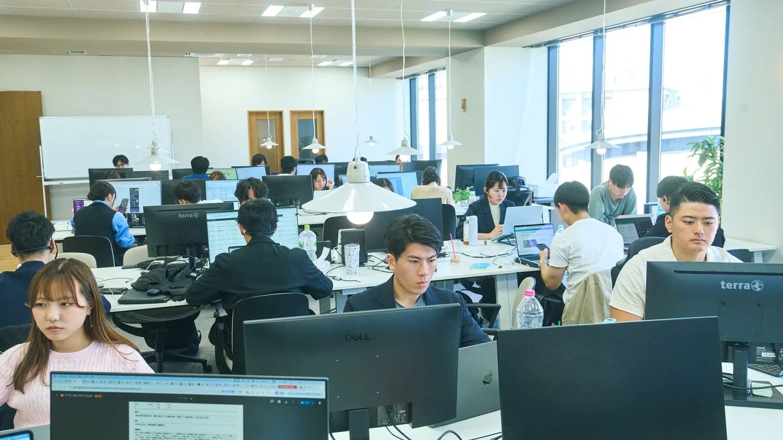 複数のモニターで広告とコンテンツの成果を確認するマーケティングチーム